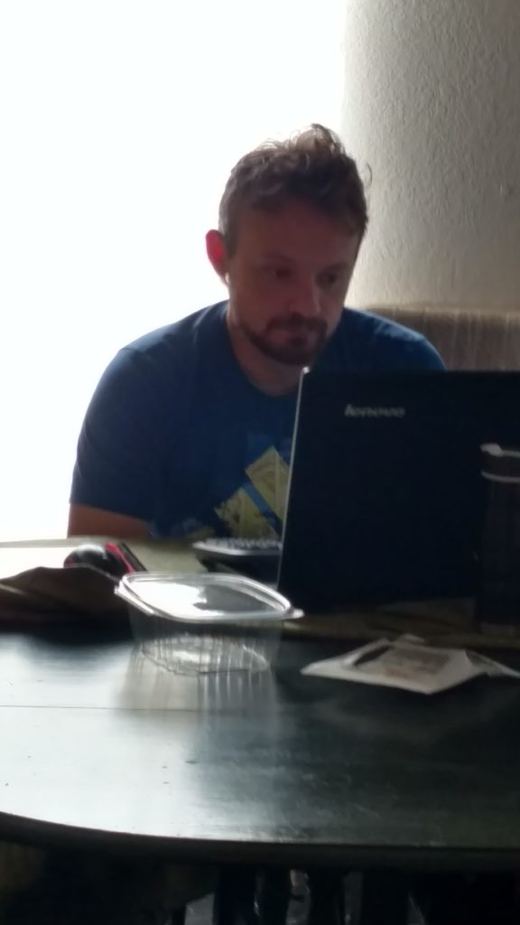 Mike, sleepy-headed, working from my dining room one morning.